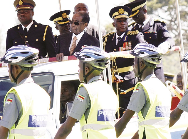 President Mugabe along with Police Commissioner-General Dr Augustine Chihuri, inspect a police parade at Morris Depot in Harare yesterday