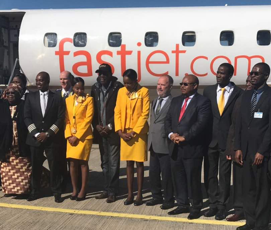 Maiden flight ... FastJet chairman Farai Mutamangira (fourth from right) poses for a picture at the Joshua Mqabuko Nkomo International Airport with crew and music star Oliver Mtukudzi after the maiden flight