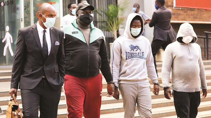 DJ Fantan, real name Arnold Kamudyariwa (second from left) and Levels, real name Tafadzwa Kadzimwe, (second from right) appear at the Harare Magistrates’ Courts yesterday. — Picture: Lee Maidza
